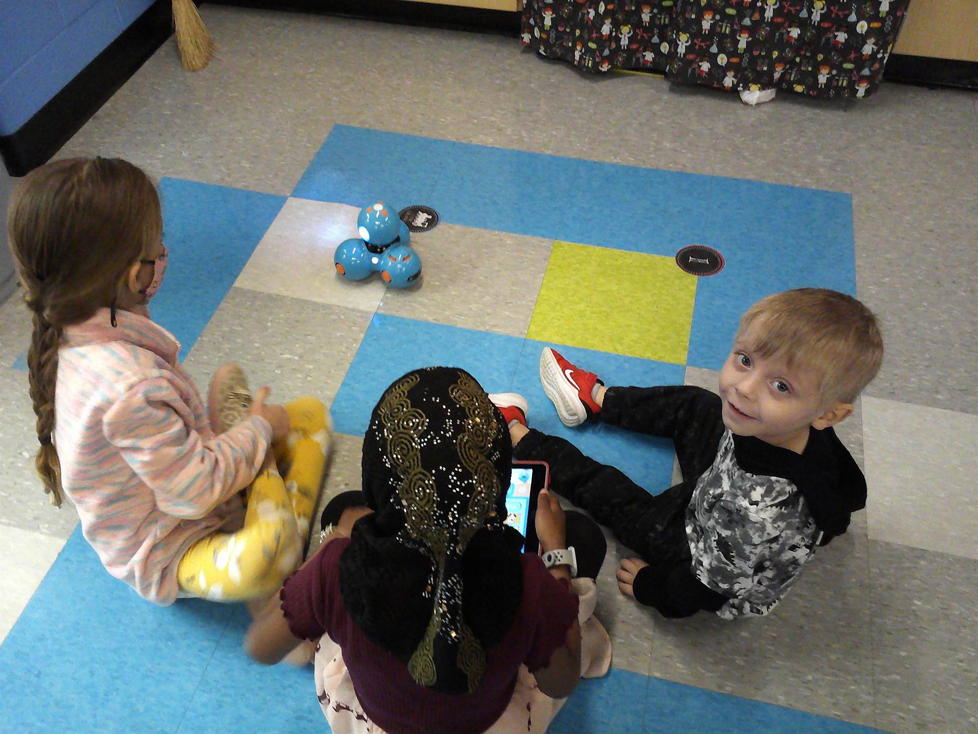 Students on floor with robot