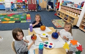 Students painting pumpkins