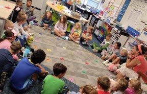 first grade class in a circle learning