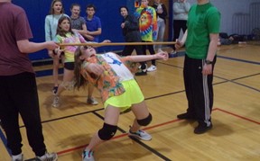 Student doing the limbo at Fun in the Sun Assembly