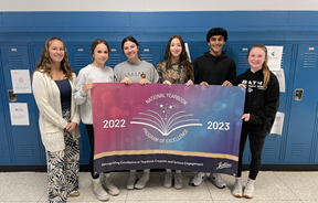 Students holding banner