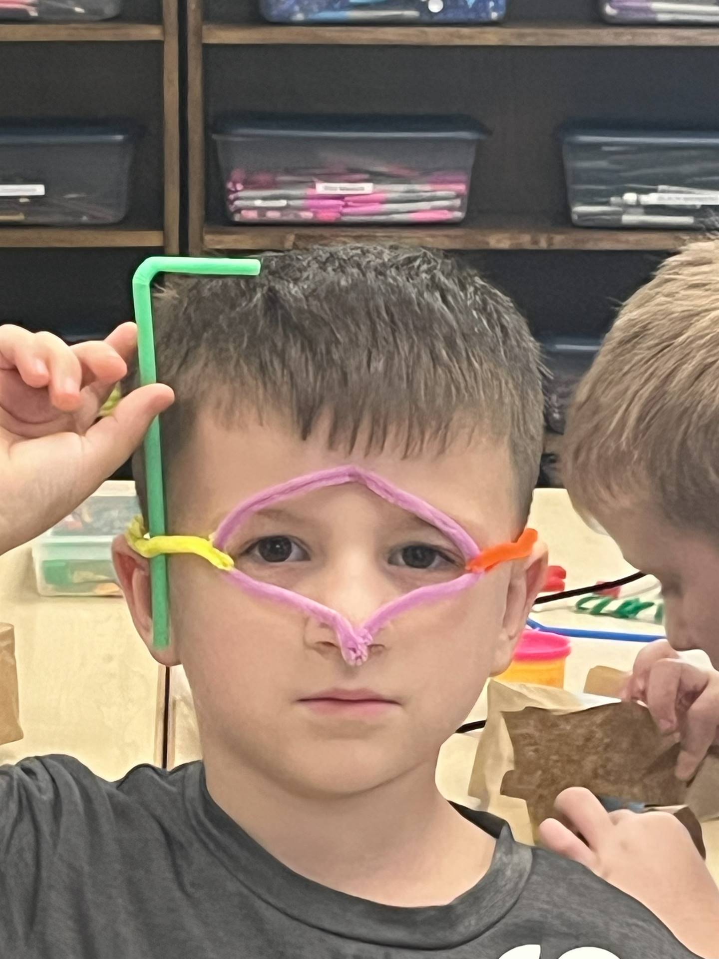Student with pipe cleaner googles