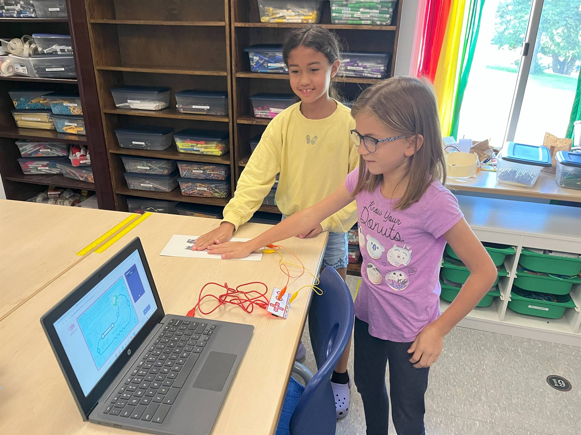 Students looking a computer