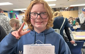 Student holding a poem