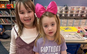 first graders posing at reading table